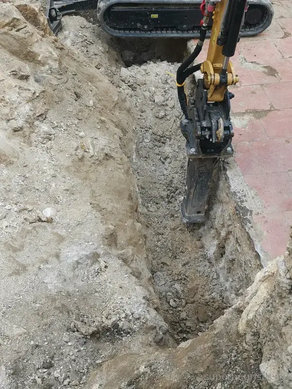 Detail hydraulického kladiva pri sekaní skalného podložia
